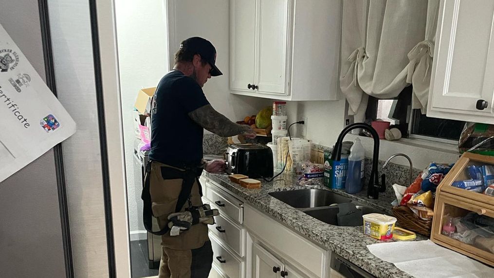 Los Banos Fire Cpt. Thompson making breakfast for children before school after their mother was taken to the hospital. (Photo: Los Banos Fire)