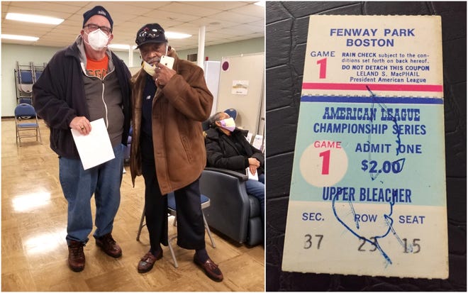 Michael Doyle, left, of Ogunquit, Maine, poses with Boston Red Sox pitcher Luis Tiant of Wells, Maine, after the two men crossed paths at York Hospital’s COVID-19 Vaccine Clinic at St. Christopher’s Church in York, Maine, on Feb. 9, 2021. Tiant autographed Doyle's ticket to an American League Series game at Fenway Park on Oct. 4, 1975, which Doyle had kept on hand hoping the two would cross paths.