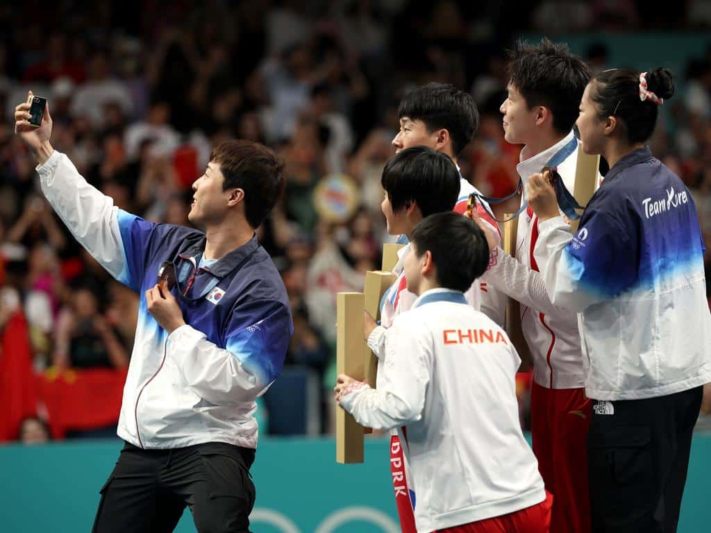 North Korea’s Ri Jong Sik and Kim Kum Yong, the South’s Shin Yu-bin and the victorious Chinese team Wang Chuqin and Sun Yingsha could all be seen smiling.